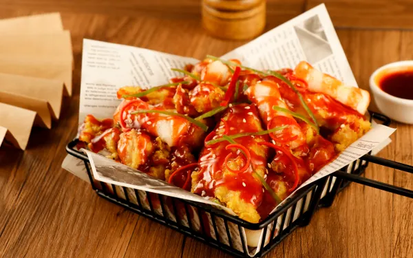 A box filled with golden Korean fried chicken